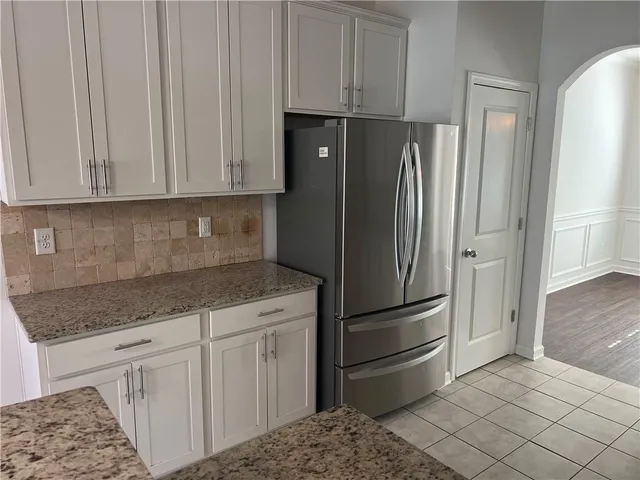 a kitchen with appliances cabinets and a counter top space