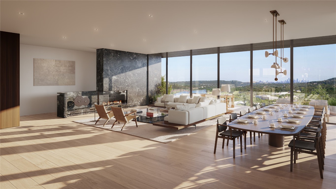 a very nice looking living room with a large window and dining table