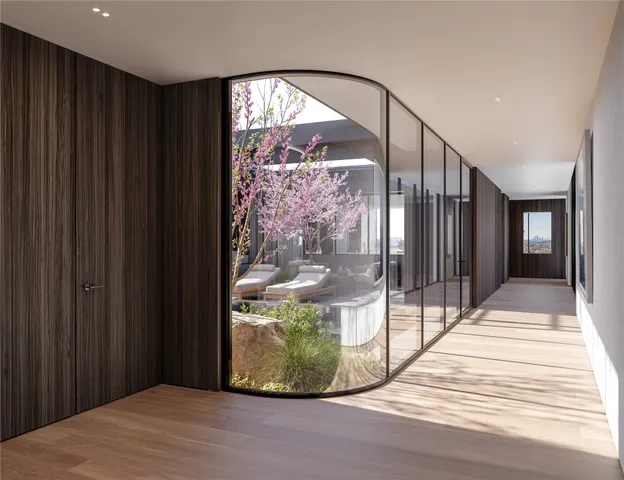 a living room with furniture and a floor to ceiling window