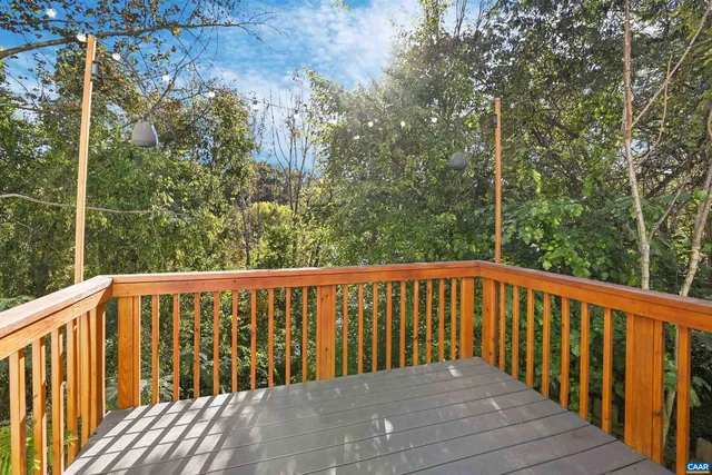 a balcony with wooden floor and fence
