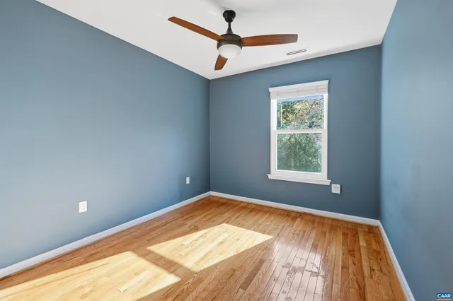 a view of a room with a window and a ceiling fan