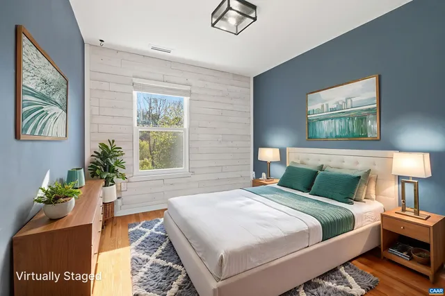 a bedroom with a bed and a potted plant