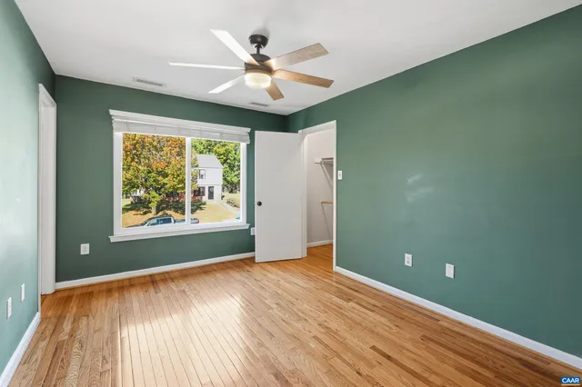wooden floor in an empty room with a window