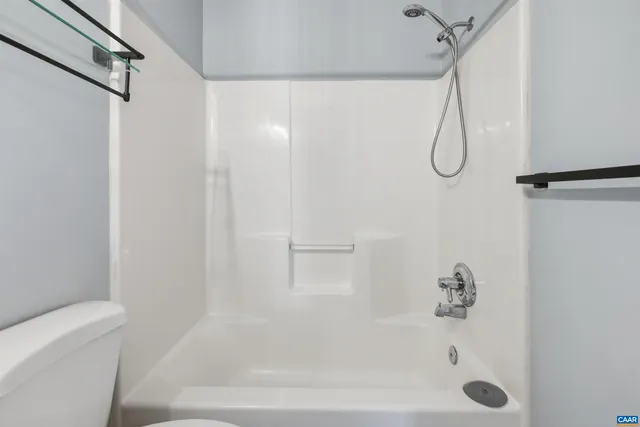a bathroom with a bath tub with a shower