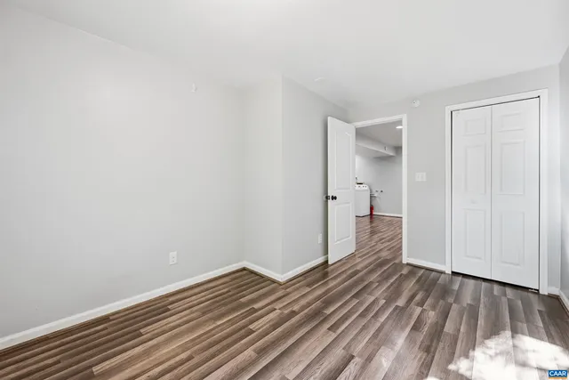 a view of a room with wooden floor