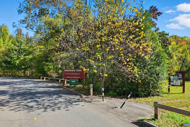 a wooden bench with trees in the background