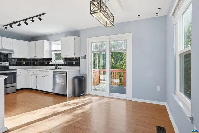 a kitchen with cabinets a sink and appliances