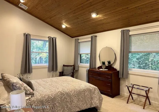 a bedroom with a bed and a desk