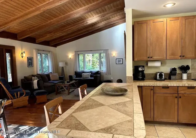 a kitchen with furniture a counter top space a sink a window and appliances