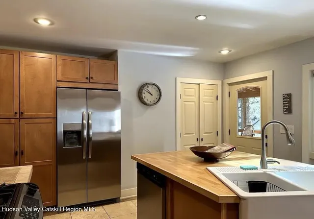 a kitchen with stainless steel appliances granite countertop a sink and a refrigerator