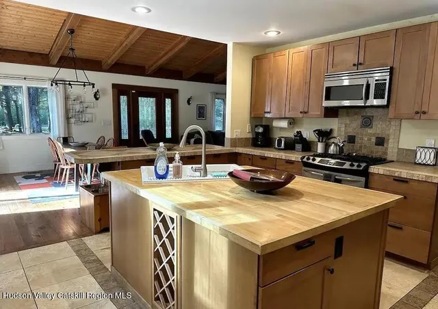 a kitchen with a stove a sink and a refrigerator