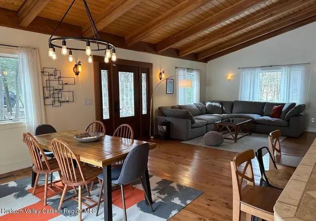 a view of a dining room with furniture window and wooden floor