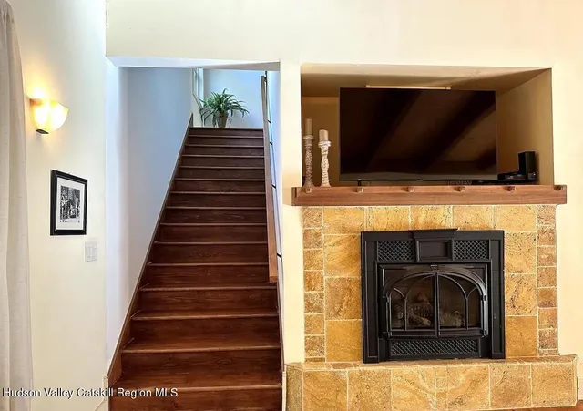 a living room with a fireplace and a flat screen tv