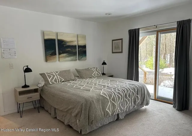 a bedroom with a bed and window