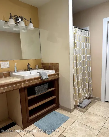 a room with a sink and a mirror