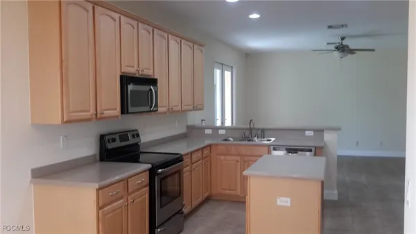a utility room with sink dryer and washer