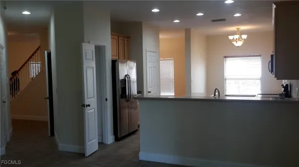 a kitchen with stainless steel appliances a refrigerator and a sink