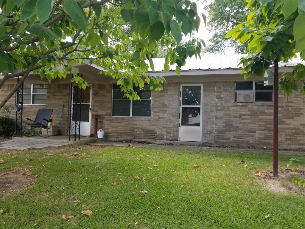 a backyard of a house with table and chairs