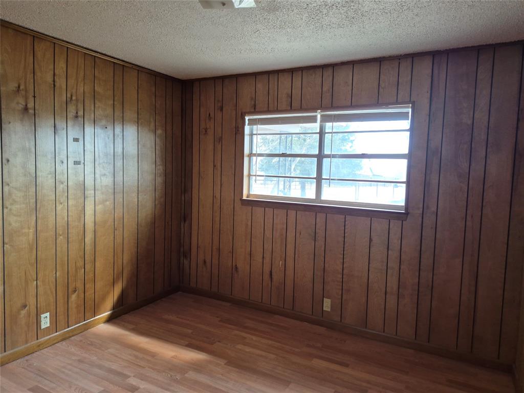 38 County Road 1180 Cooper, TX 75432 - Photo 14 of 25 an empty room with wooden floor and a window