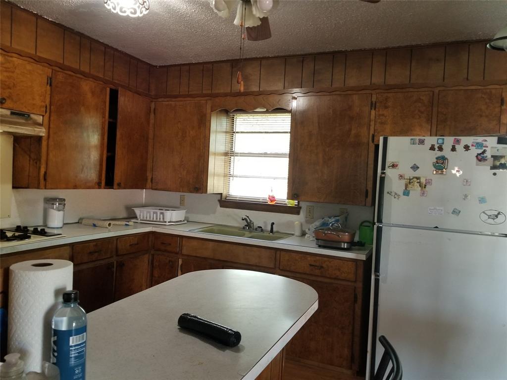 38 County Road 1180 Cooper, TX 75432 - Photo 20 of 25 a kitchen with a sink a stove a refrigerator and cabinetry