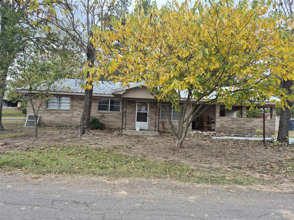 38 County Road 1180 Cooper, TX 75432 - Photo 2 of 25 a front view of a house with a tree