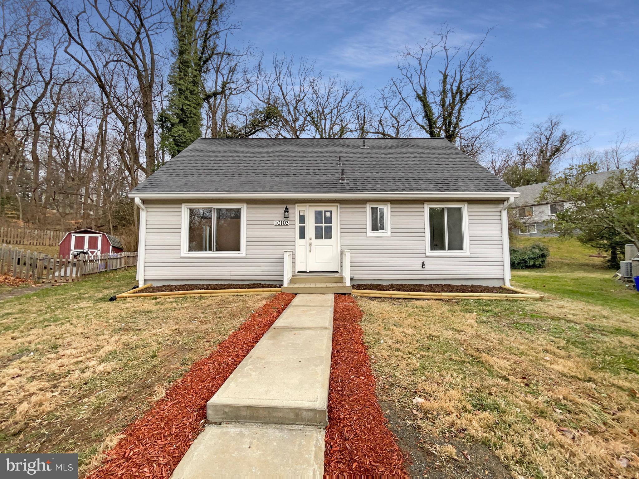 a view of a house with a yard covered with snow