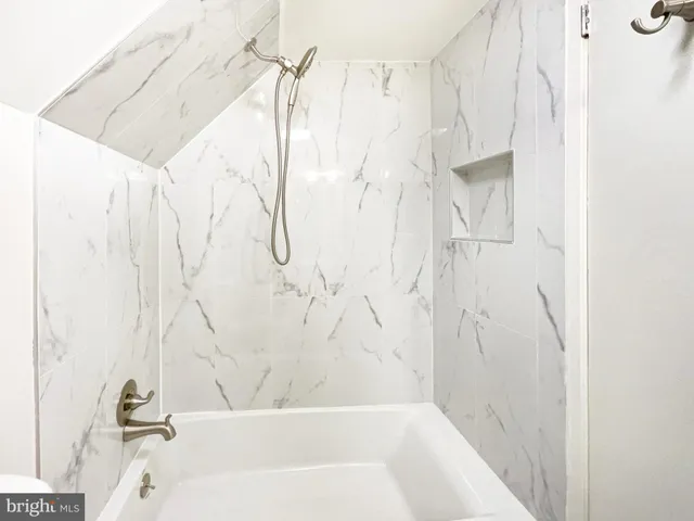 a bathroom with a bathtub and shower