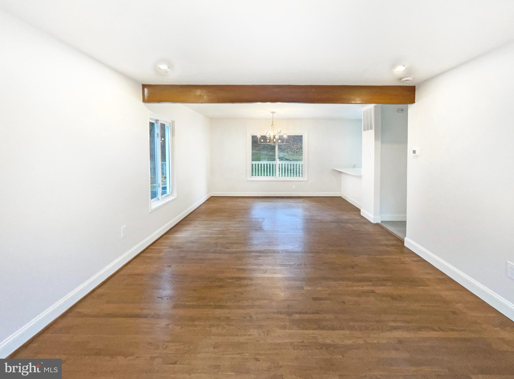 10103 Meredith Avenue Silver Spring, MD 20910 - Photo 3 of 23 a view of an empty room with wooden floor and a window