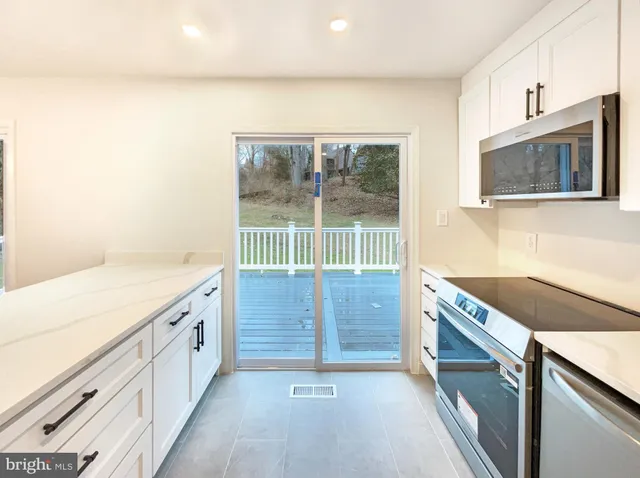 a kitchen with granite countertop a sink and a stove top oven