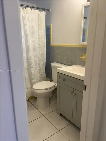 a bathroom with a toilet a sink and a shower