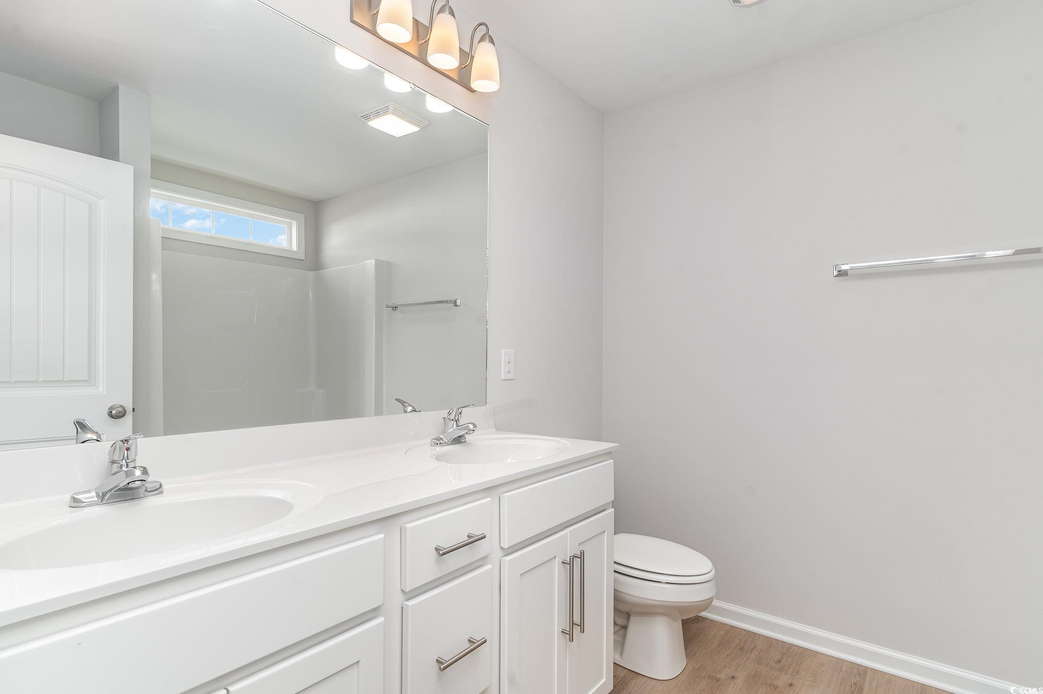 330 Barn Owl Way Conway, SC 29526 - Photo 14 of 23 Bathroom with double vanity and light wood-style floors