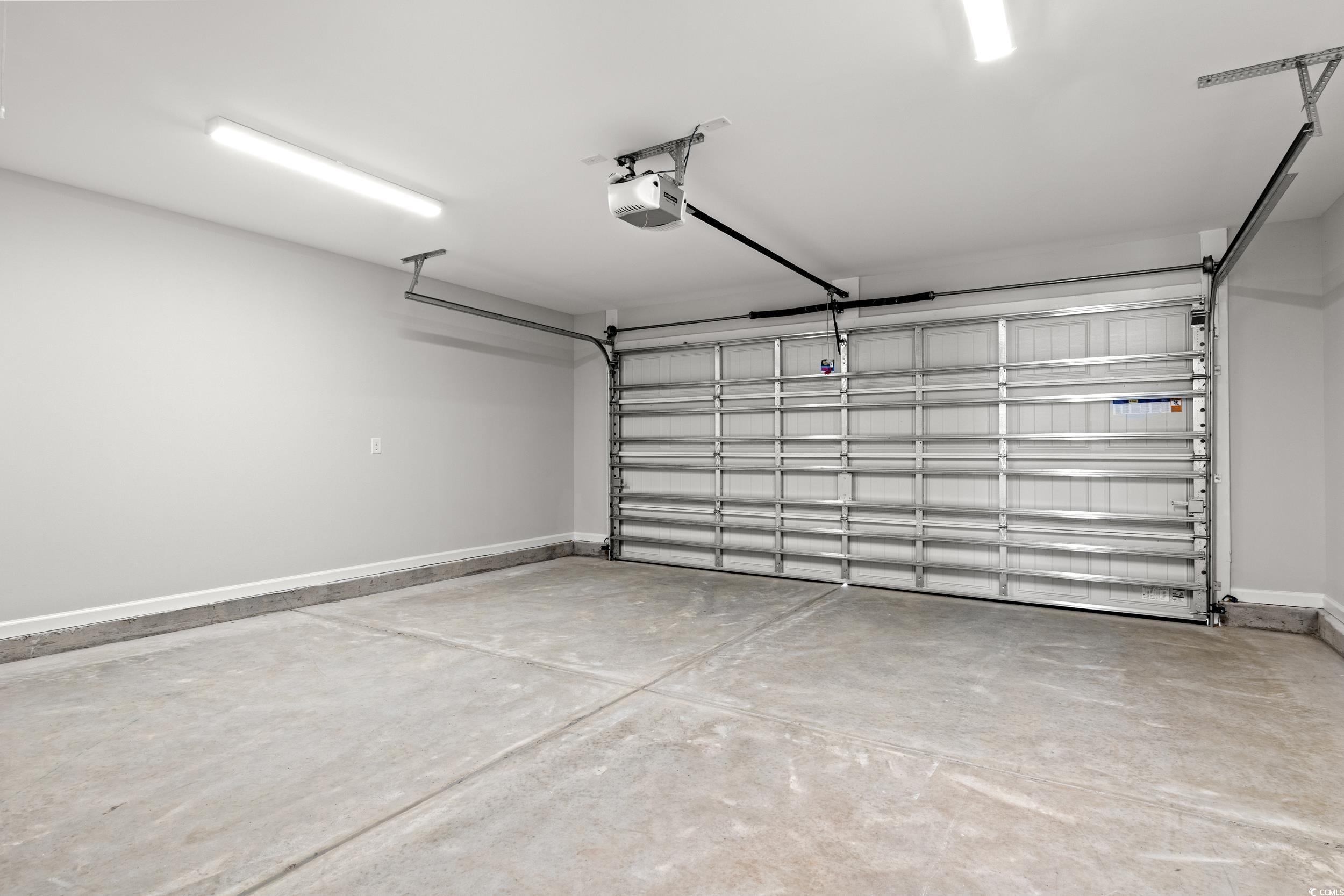 330 Barn Owl Way Conway, SC 29526 - Photo 23 of 23 Garage with baseboards and a garage door opener