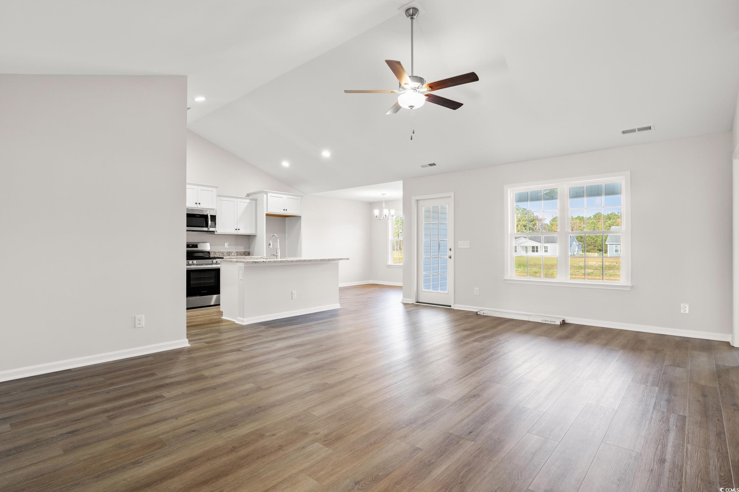330 Barn Owl Way Conway, SC 29526 - Photo 3 of 23 Unfurnished living room featuring a ceiling fan, dark wood-style floors, high vaulted ceiling, a chandelier, and recessed lighting