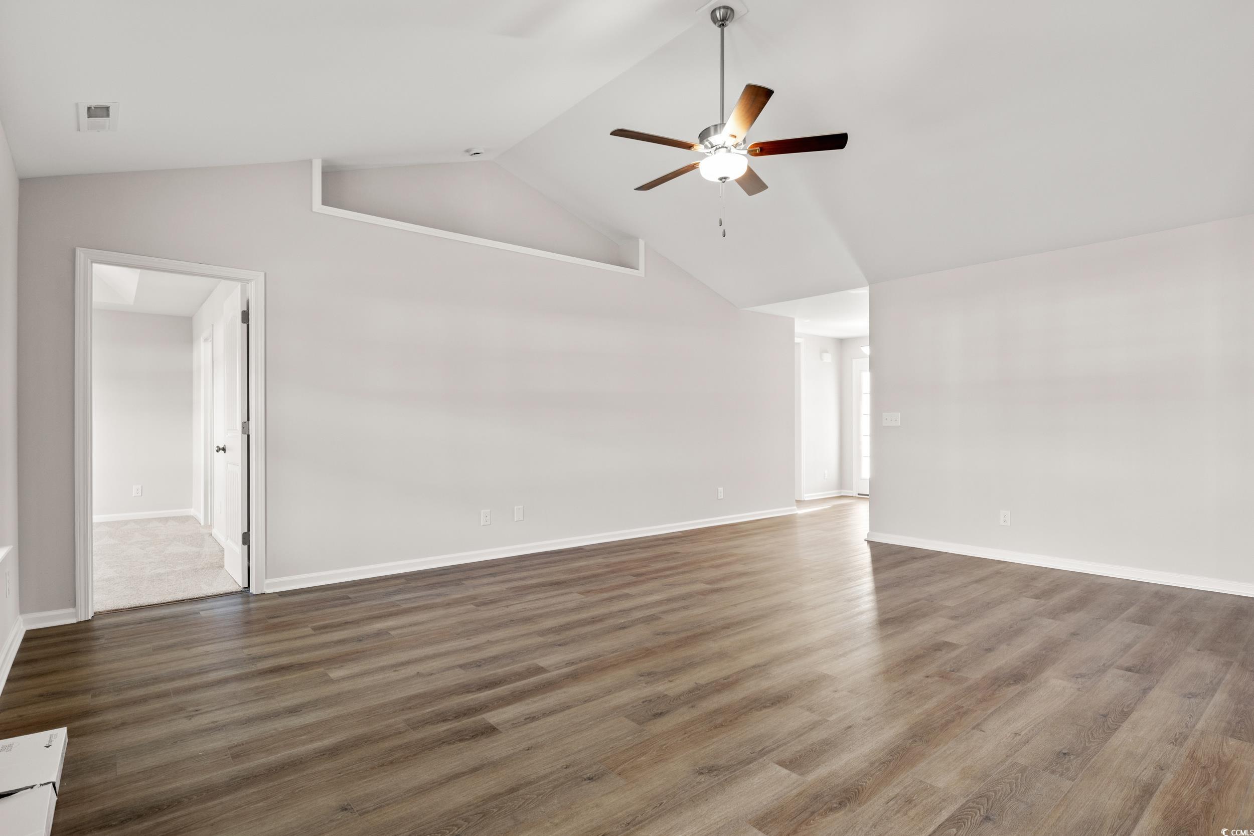 330 Barn Owl Way Conway, SC 29526 - Photo 5 of 23 Empty room featuring dark wood-style floors, high vaulted ceiling, and a ceiling fan