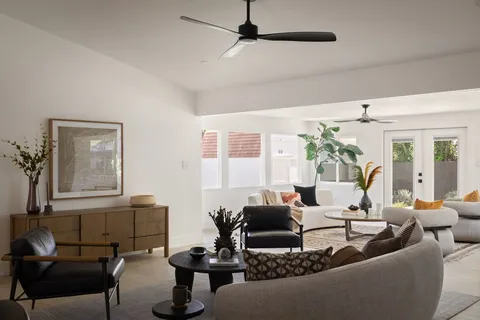 a living room with furniture and a potted plant