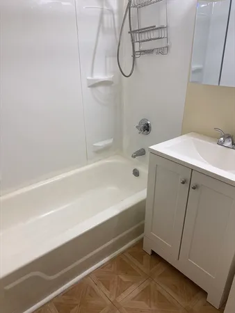 a bathroom with a bathtub and a shower