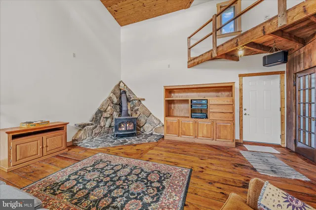 a view of an empty room with a fireplace and a window