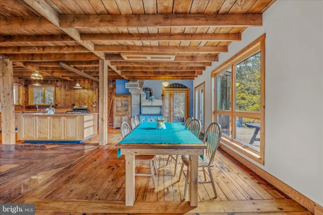 a view of a chairs and table on the wooden deck
