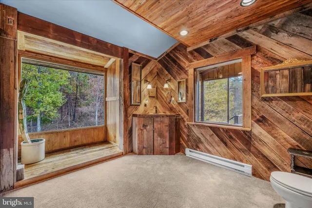 a bedroom with a bed and a dresser next to a window
