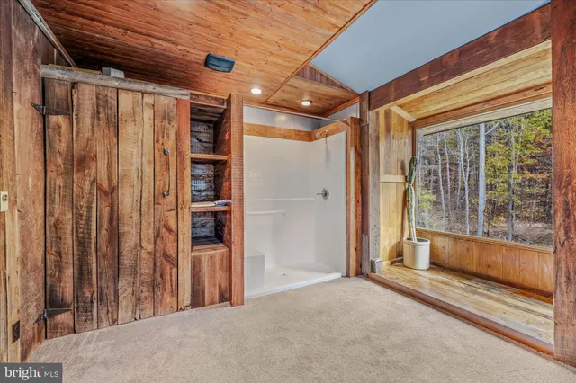 a bedroom with a large bed and a large window