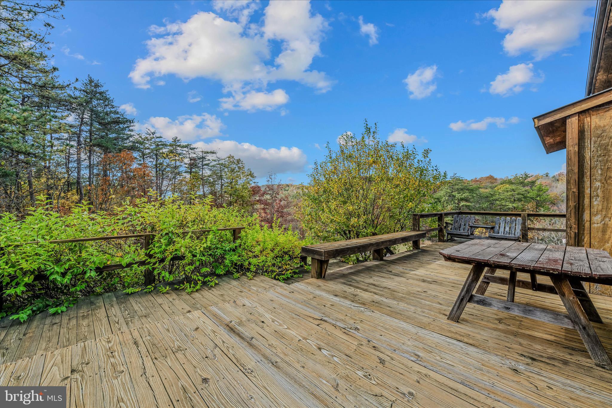 3041 Pine Grove Road Berkeley Springs, WV 25411 - Photo 28 of 99 a view of a chairs and table on the wooden deck