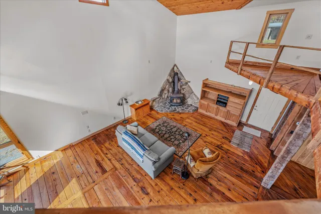 a view of an empty room with a window and fireplace