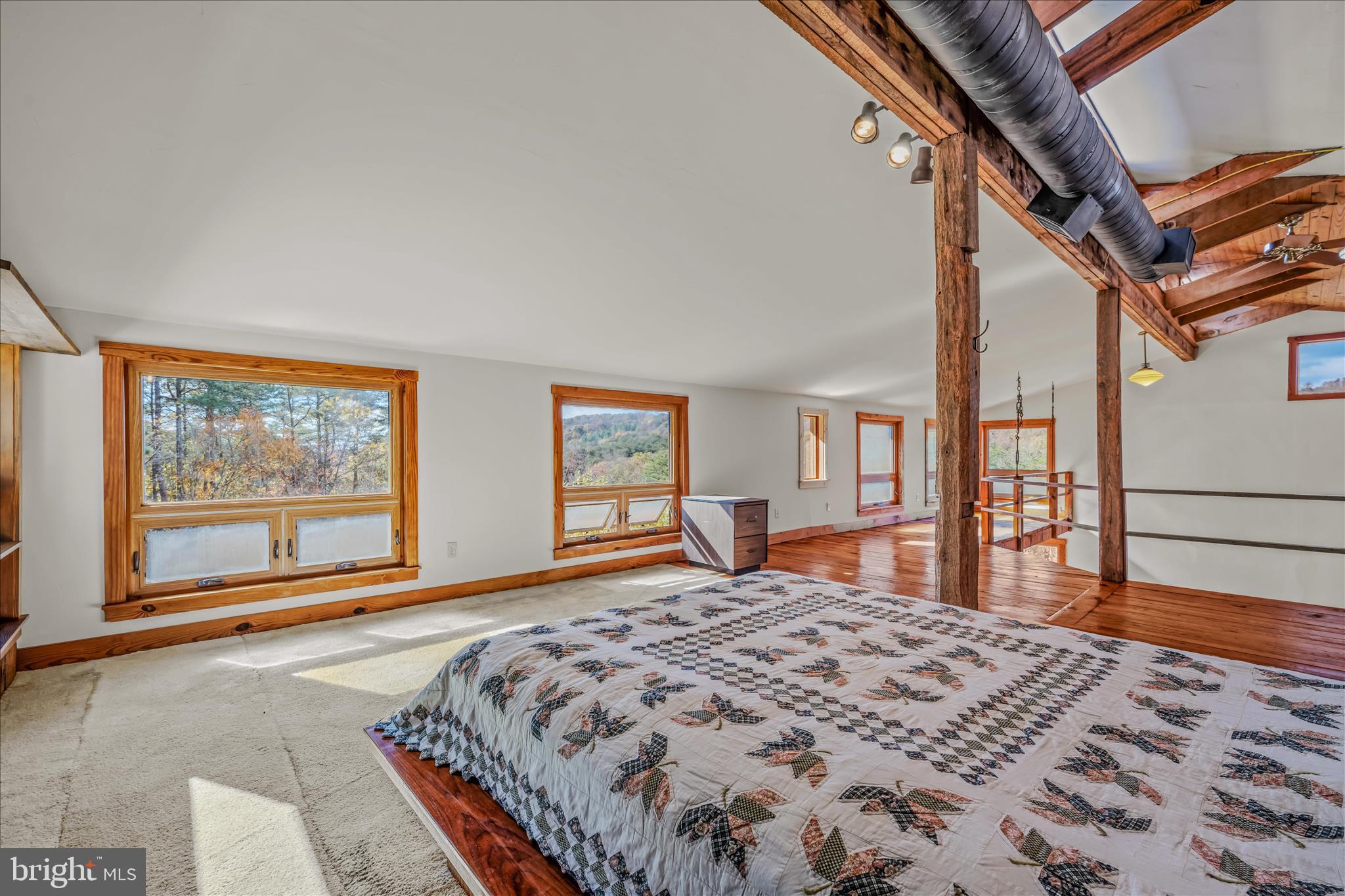 3041 Pine Grove Road Berkeley Springs, WV 25411 - Photo 38 of 99 a bedroom with a large bed and a large window