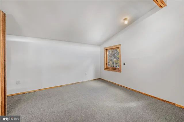 a backyard of a house with lots of green space and chair