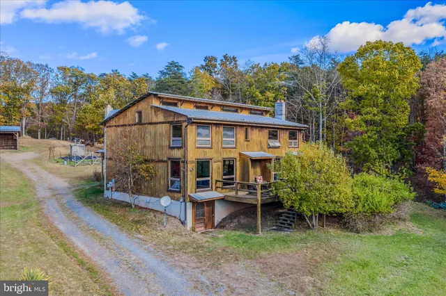 a view of a house with swimming pool and porch