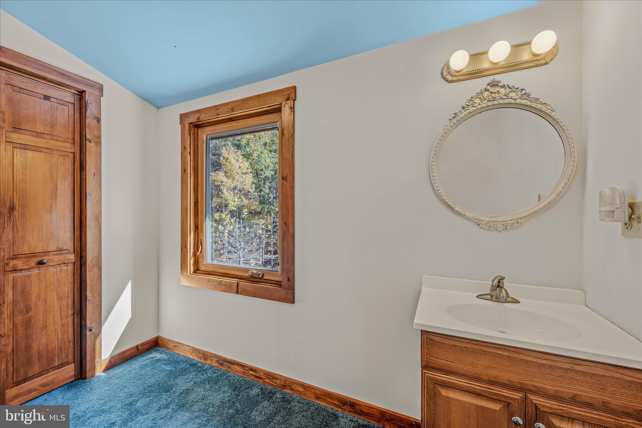 3041 Pine Grove Road Berkeley Springs, WV 25411 - Photo 42 of 99 a bathroom with a granite countertop sink and a mirror
