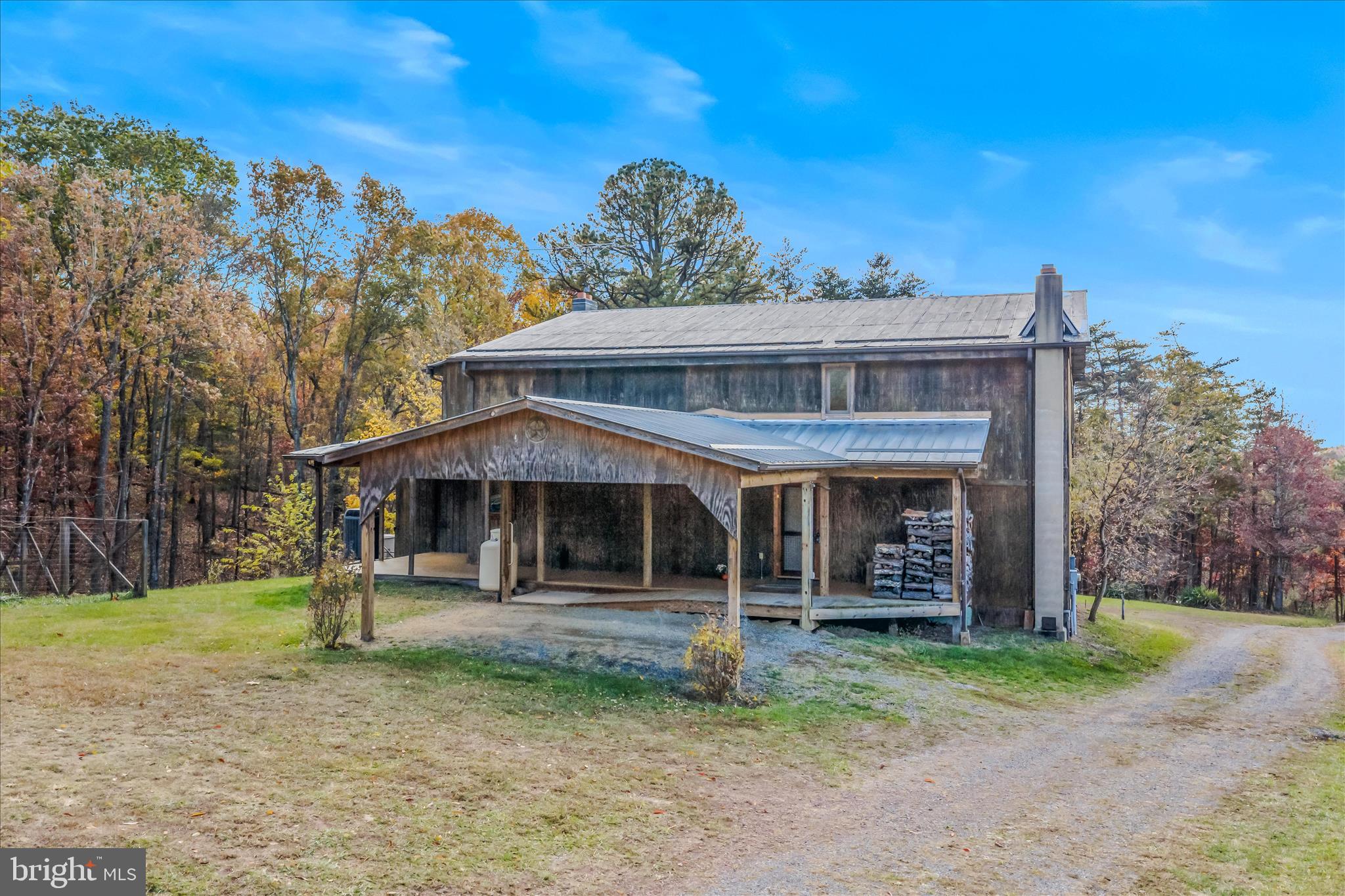 3041 Pine Grove Road Berkeley Springs, WV 25411 - Photo 7 of 99 a front view of a house with garden