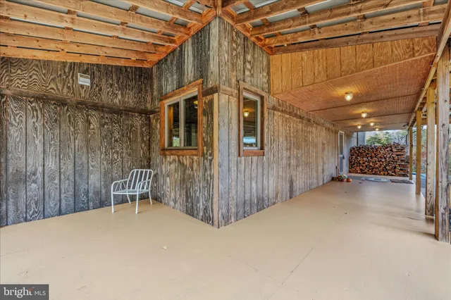 a view of a porch with wooden floor and entrance