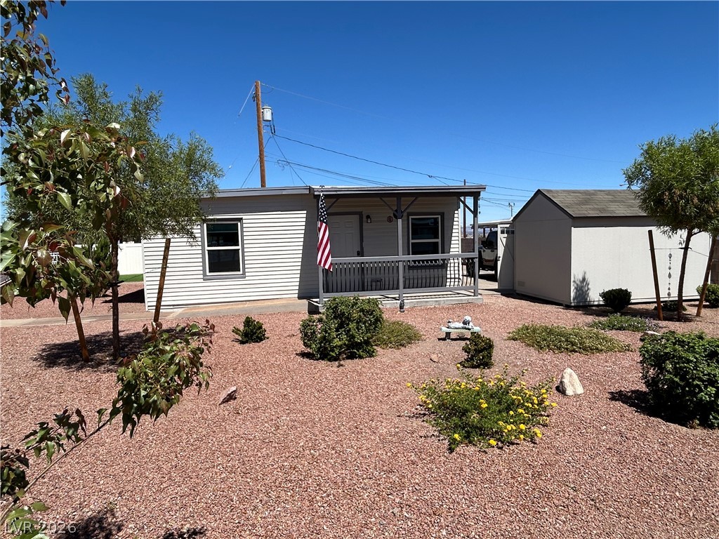 116 West Basic Road Henderson, NV 89015 - Photo 6 of 39 A welcoming front porch enhances this charming residence, complemented by a convenient shed and low-maintenance landscaping.