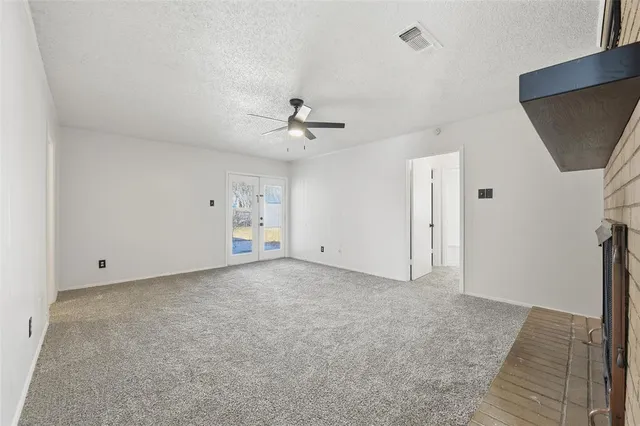 a view of an empty room with a fireplace